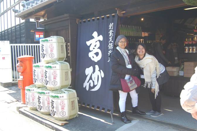 Joyce and I with the sake barrels at Fuji Takasago Sake Brewery store entrance (Photo credit: Song Dimacale)